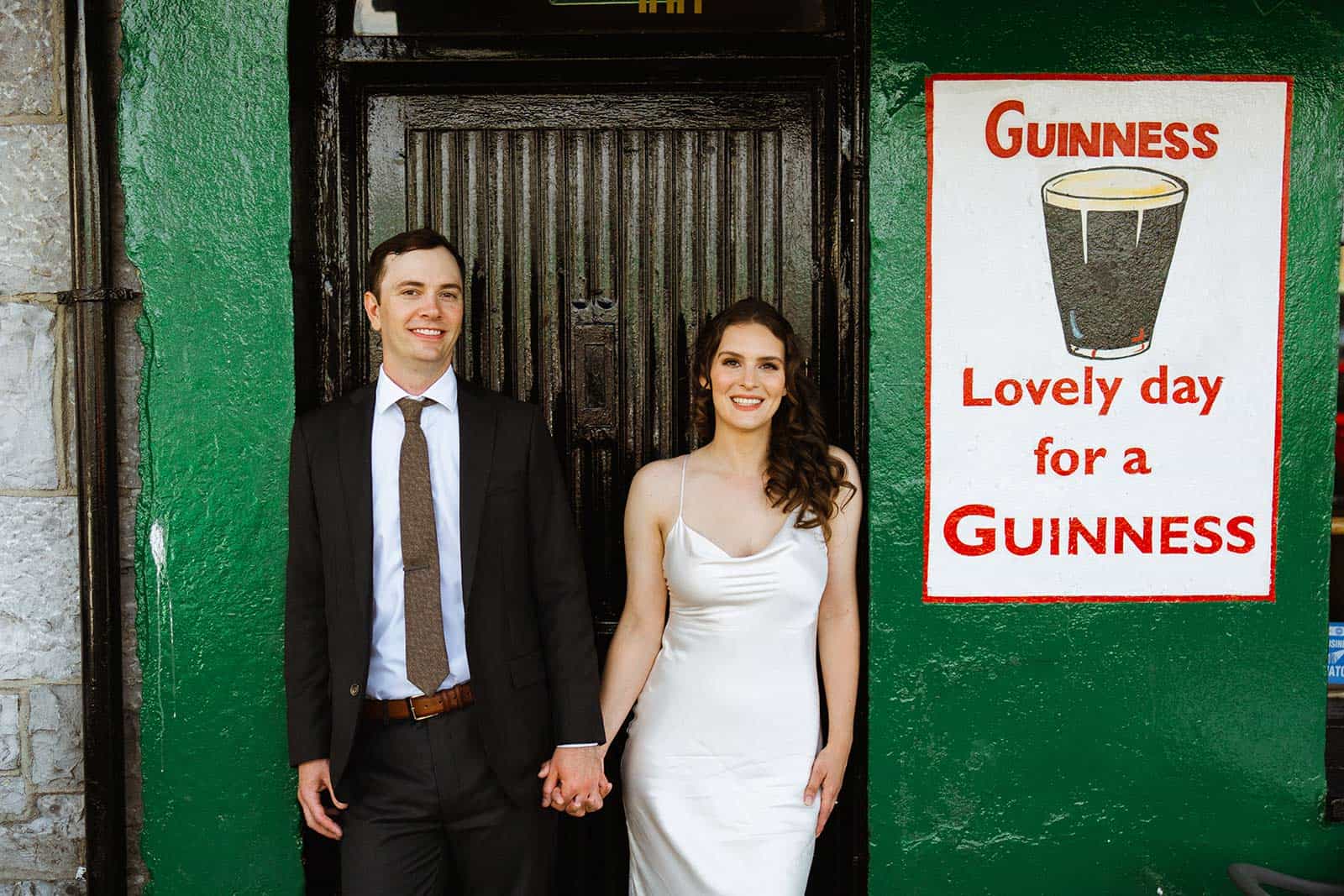 couple at doorway of pub while eloping in ireland