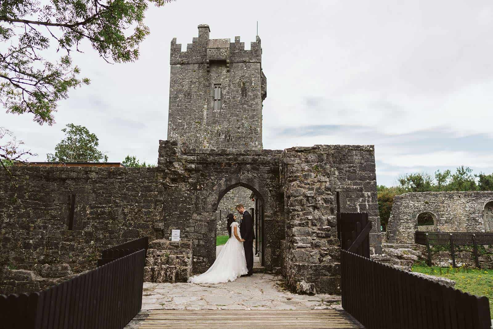 couple at castle ruin on wedding day eloping in Ireland