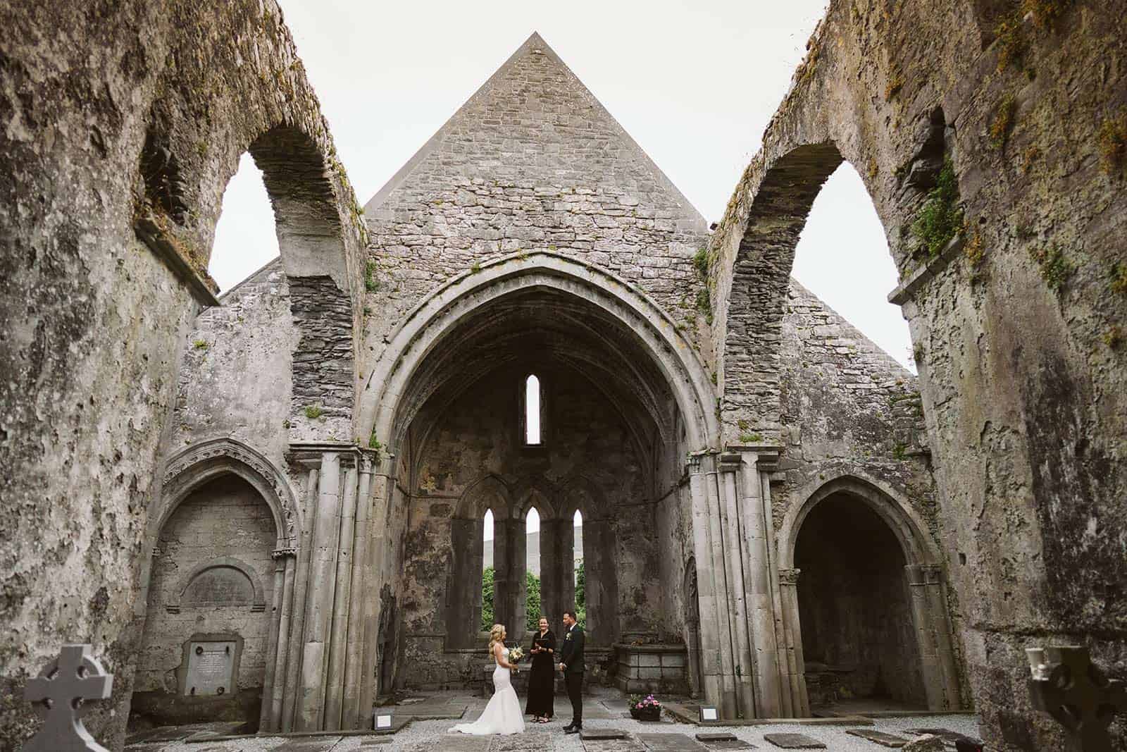 couple at abbey ruin eloping in ireland