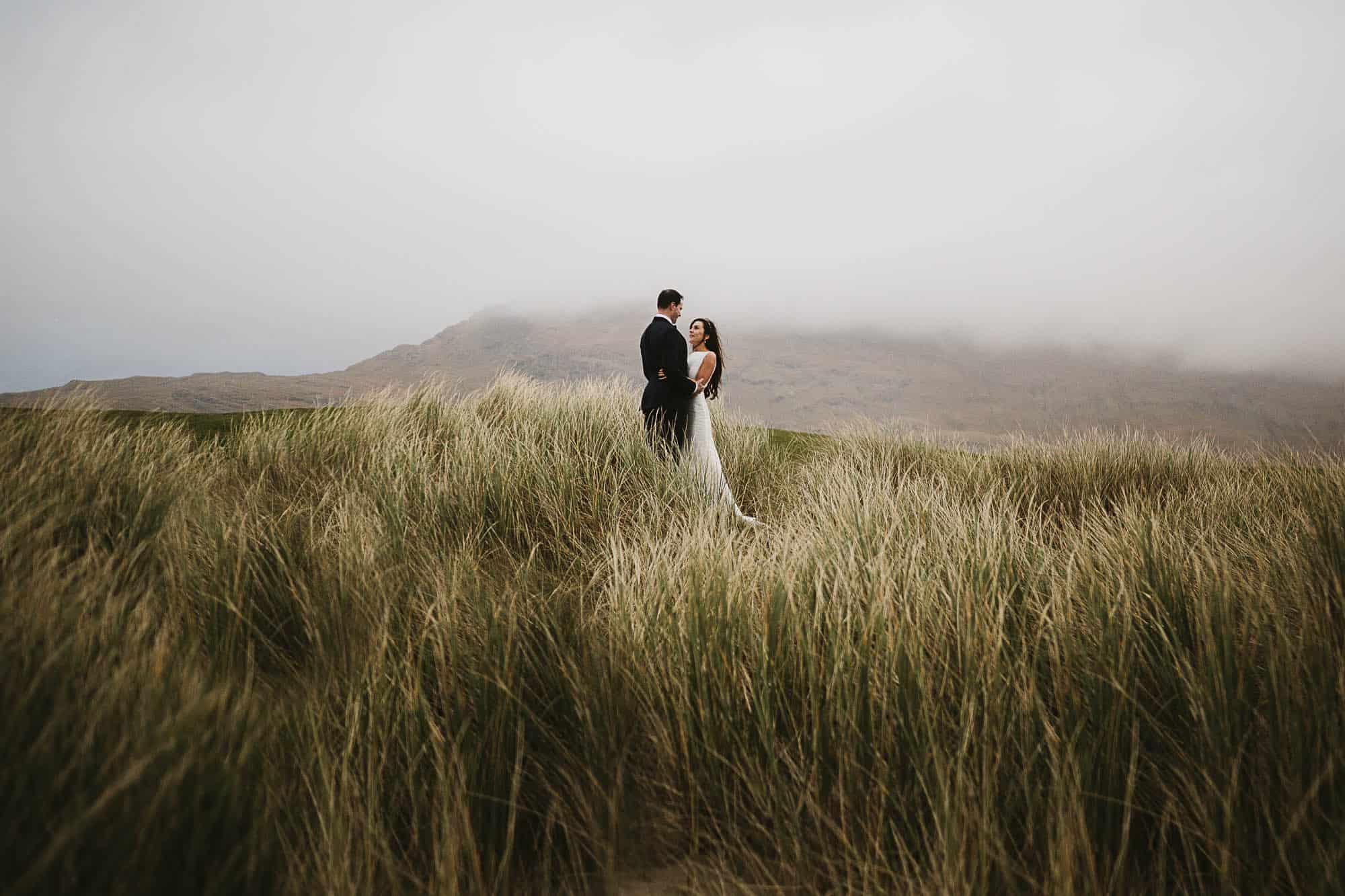 best places to elope, Connemara Elopement Adventure Ireland, a couple hold each other in the Grasslands
