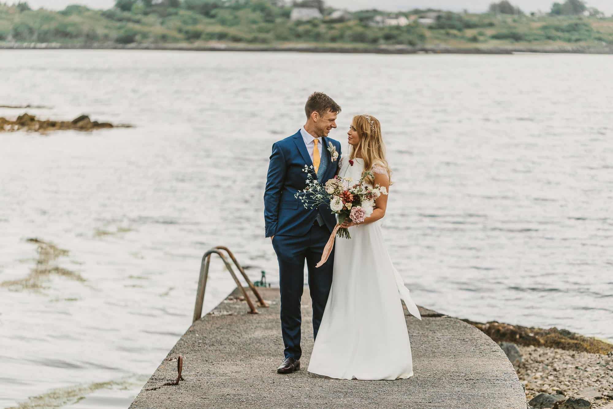 Elopement Ireland Connemara Before Ceremony couple are standing on a pier smiling