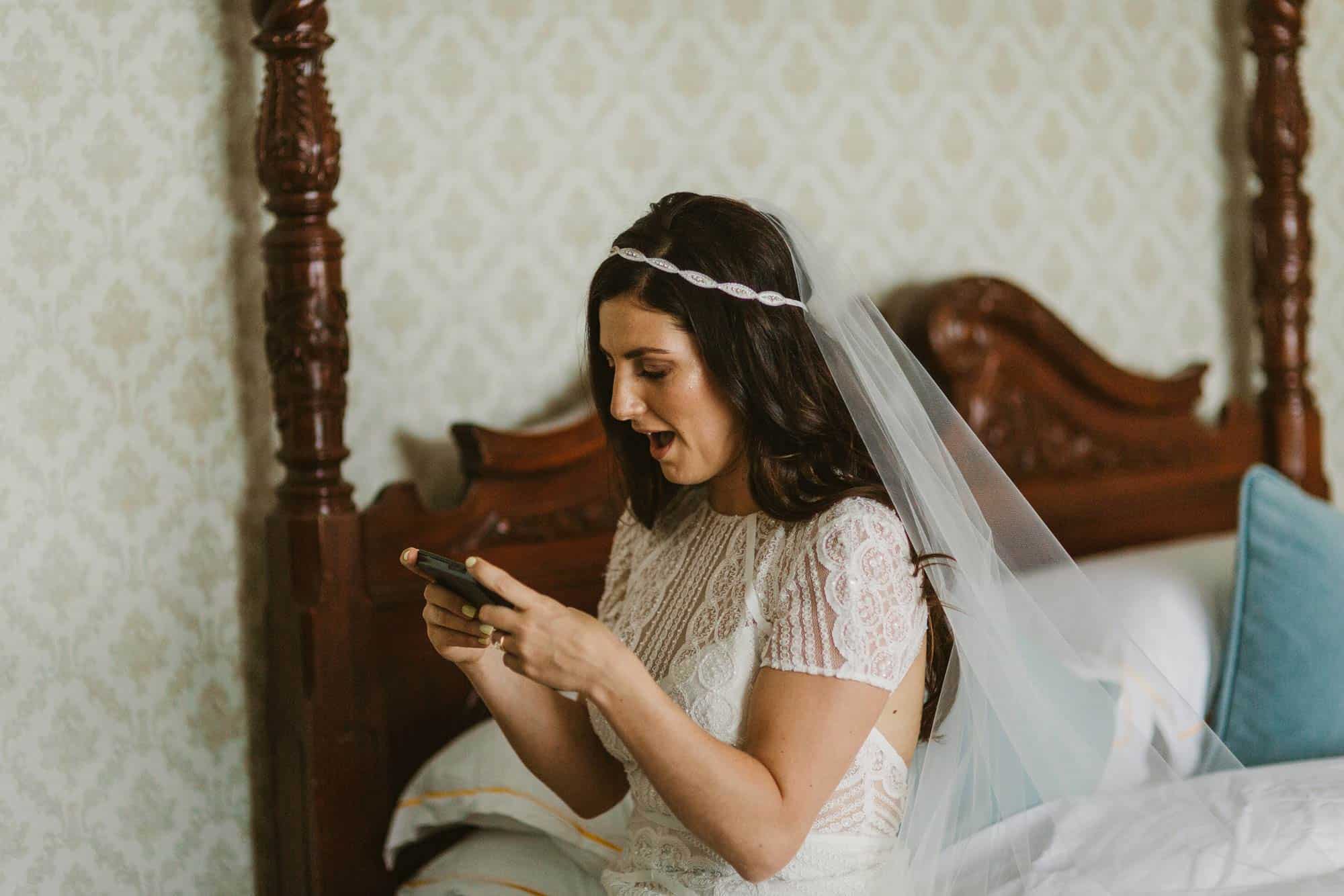 Elopement videographer Ireland, bride looking at messages on her phone