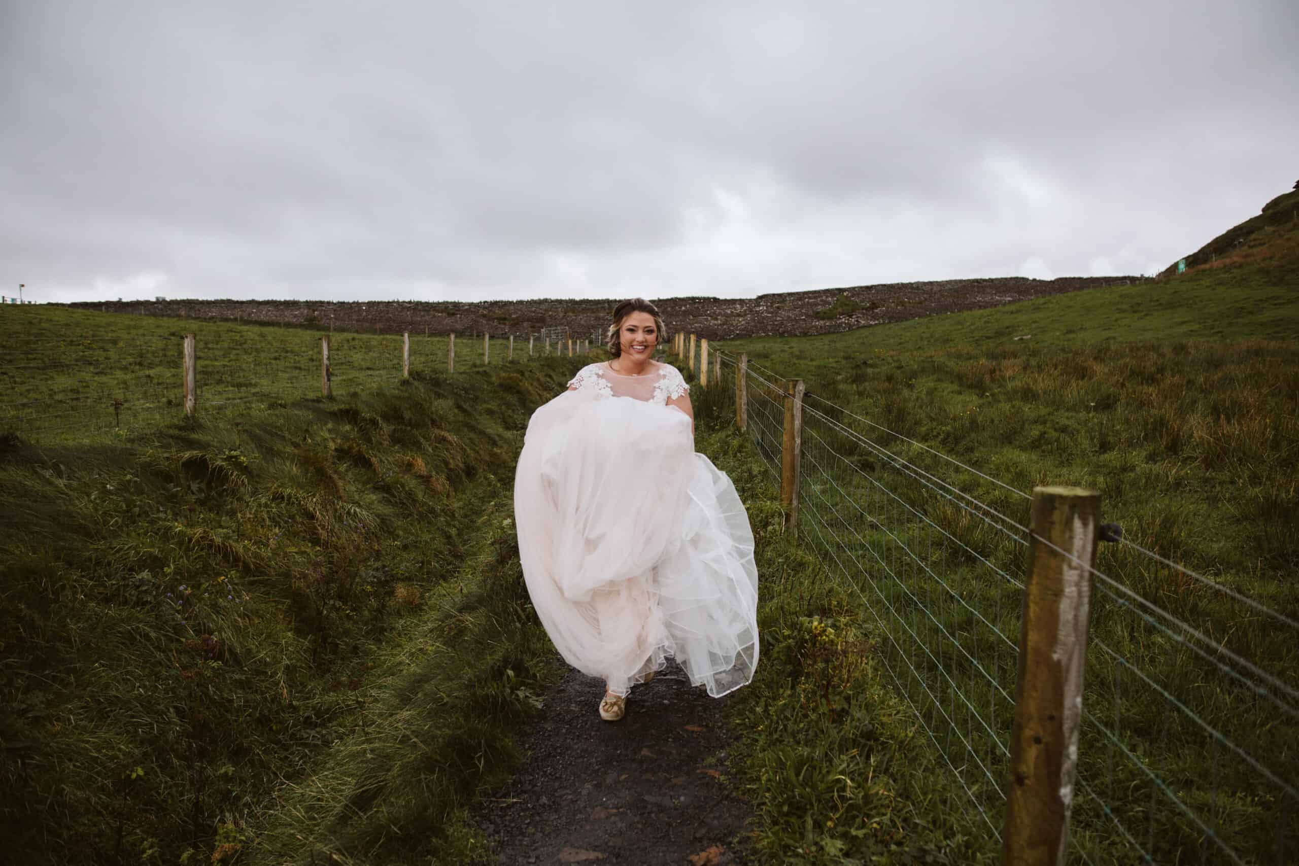 Cliffs of Moher Wedding Hags head, bride walking through a field, lifting her dress